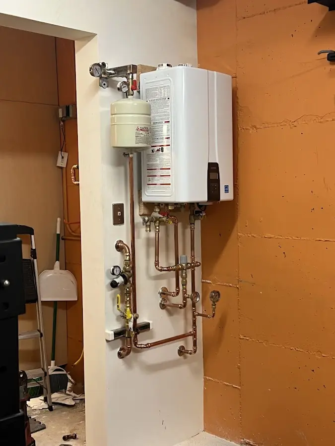 Plumbing technician inspecting water heater connections in Apache Junction